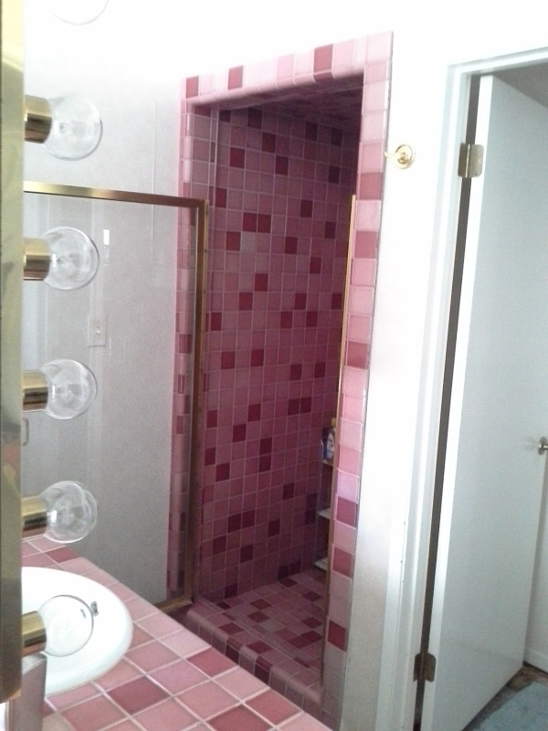A bathroom with pink tiles